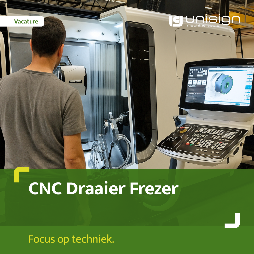 Person operating a CNC milling machine, facing the open machine door with a control panel nearby in a workshop setting